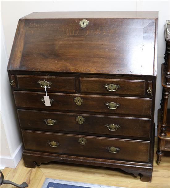 A George III oak bureau with fitted interior W.94cm